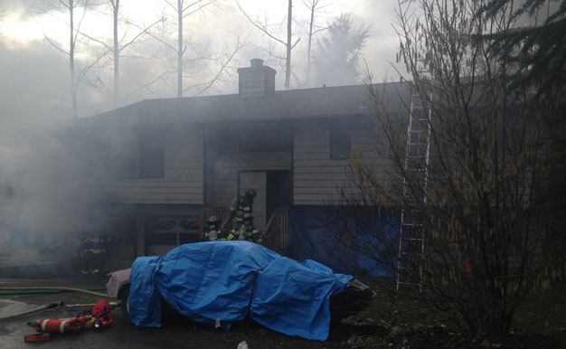 Firefighters battle a blaze Tuesday at a Kent home in the 20200 block of 140th Place Southeast.
