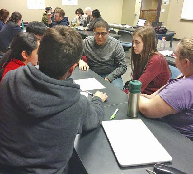 Green River College students create paper prototypes of a new website for the Kent Food Bank. Paper protoyping is a widely-used method that helps developers test the usability of a given design.