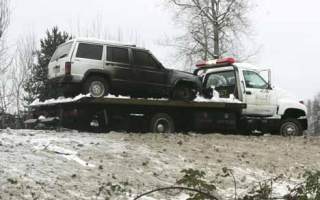 Valley Towing takes away the SUV that caught fire on Highway 167 before the Willis Street exit Tuesday morning.
