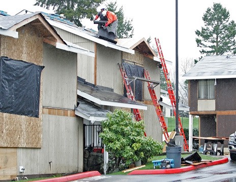 Crews from CDK Construction Services of Duvall work Dec. 23 to re-roof an apartment at the Cascade Apartments in the Panther Lake area of Kent as part of a $3.5 million King County Public Housing Authority project.