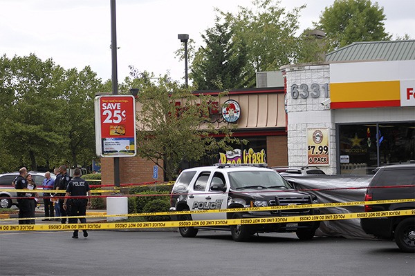 Two men were shot to death at about 8:40 a.m. Tuesday in the parking lot of the Shell gas station on South 212th Street.