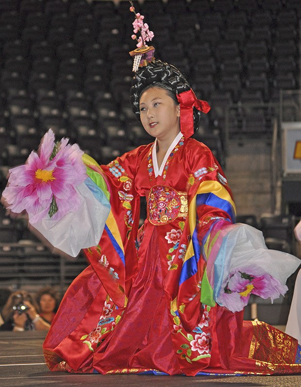 A girl from the Northwest Culture Foundation performs a Korean dance during the Kent International Festival at the ShoWare Center last Saturday..