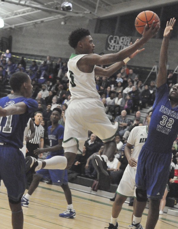 Rayvaughn Bolton drives to the basket for Kentwood against Federal Way in a district playoff game.