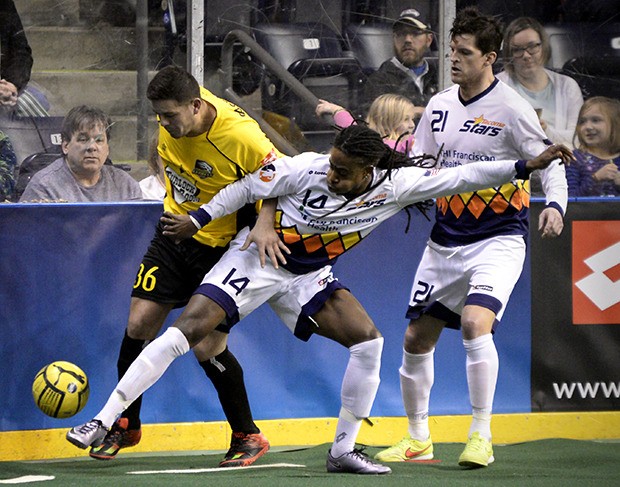 The Stars' Tyrone Hall battles an Express player for the ball with teammate Adam West nearby during action Friday night at the ShoWare Center.