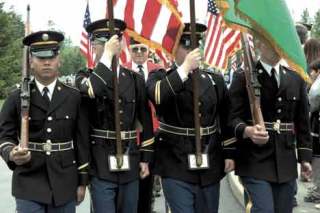 A color guard from the 2006 Memorial Day services at Tahoma National Cemetery strides in unison during the event.