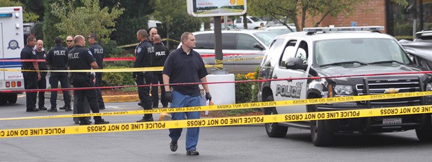 Kent Police work the scene of two shooting deaths in August at a Shell station along South 212th Street.