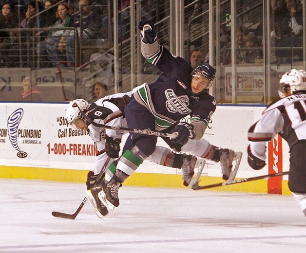 11/01/11 Thunderbird Justin Hickman collides with Giant Dalton Sward at mid-ice as he moves the puck to the neutral zone