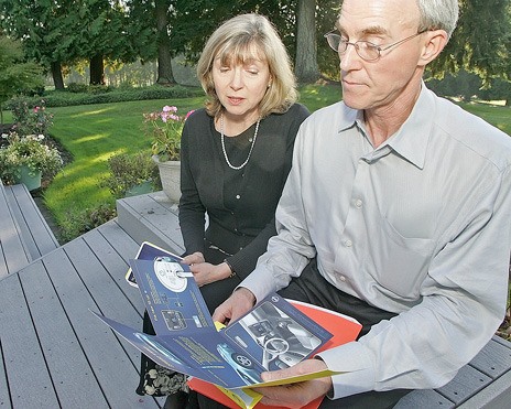 Doug and Maria Nelson of Kent look over a 2011 Nissan Leaf brochure. They plan to buy the new electric vehicle later this year.