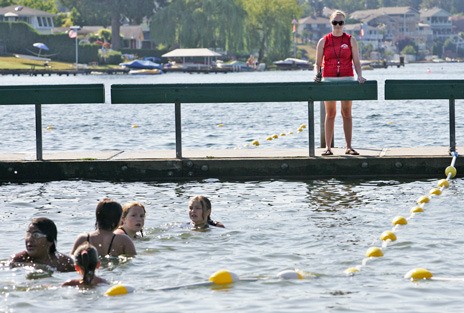 Lifeguard Alicia Flatt watches swimmers at Lake Meridian Park in Kent in this 2009 file photo. The city of Kent is now hiring lifeguards for this summer.