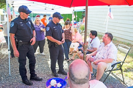 Officers visit a neighborhood during the 2013 National Night Out event in Kent. This year's event is Tuesday