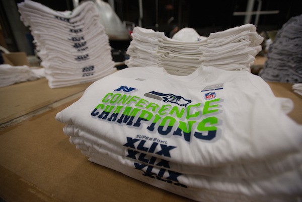 NFC Champions T-Shirts lie stacked and awaiting boxes at Kent's Polar Graphics