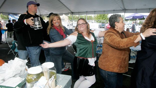 People celebrate at Kent's Oktoberfest last year. The event returns from noon to 8 p.m. Sept. 22 in downtown Kent.