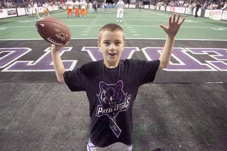 A young fan poses near the end zone at the Kent Predator's home opener March at the ShoWare Center. But are Predators' games supposed to be family entertainment?