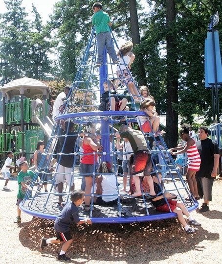 Children climb aboard the new Apollo merry-go-round at Lake Meridian Park in Kent.