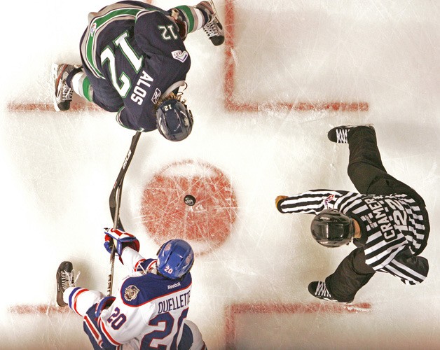 Seattle Thunderbird Tyler Alos faces off against Regina Pats' Trent Ouellette to restart play in the first period