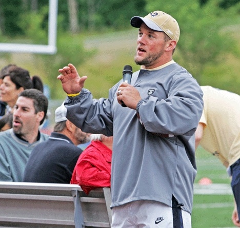 Kent’s Mike Karney takes a moment to speak to the youngsters and their parents during Saturday’s football camp at French Field.
