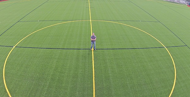 City parks planner Brian Levenhagen stands on the new synthetic turf at Wilson Playfields on the East Hill. The city spent $1.8 million to replace the old turf. The city of Kent will dedicate the new multi-use turf fields at Wilson Playfields during an official reopening ceremony at 10 a.m. Saturday