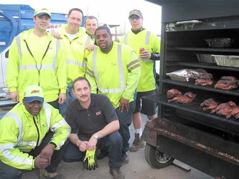 Workers at Allied Waste pause for a photo during a barbecue celebrating a near-perfect safety record for January. (Back row