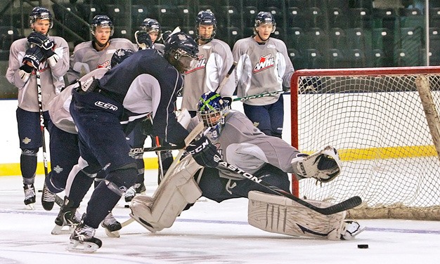 Seattle Thunderbird defenseman Dave Sutter takes a shot against goalie Michael Salmon during a practice drill Tuesday at the ShoWare Center in Kent. The T-Birds open the season Saturday
