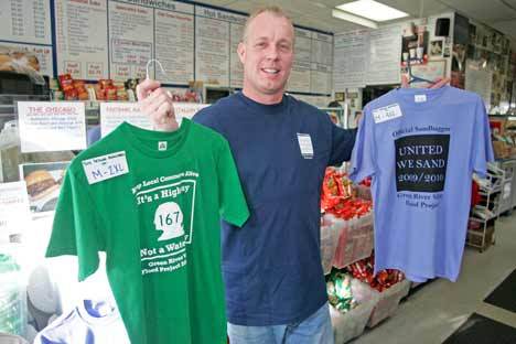Danny Kakuk is the owner of Little David's Sub Shop and the creator of “FloodShirts.com.”  Kakuk poses in his shop where the flood shirts are for sale on Dec. 3.