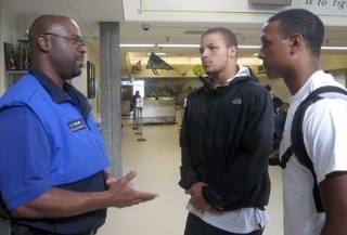 Washington State School Security Officer of the Year Dave Fowler talks with Devin Topps and Alex Ferguson during lunch Sept. 26. Topps and Ferguson are both members of the football team and the Kingsmen.