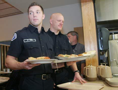 Kent firefighters Jesse Wise and Paul Conan line up to serve lunch at the Kent Fire Department annual volunteer luncheon Dec. 18.