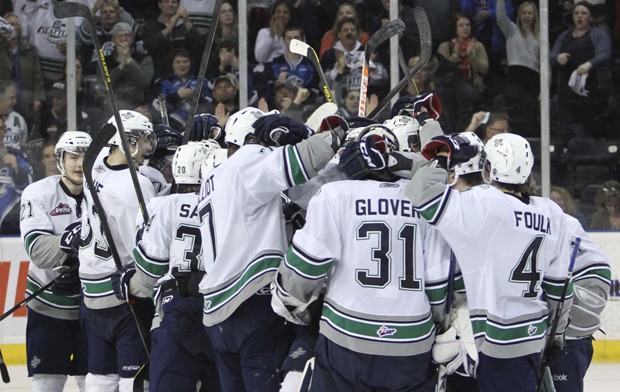 T-Bird players celebrate the Game 3 conquest of Kelowna with goalie Brandon Glover.