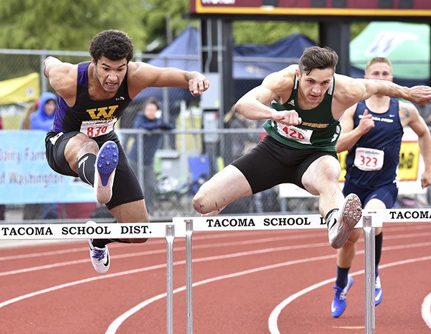 Kentridge’s Tanner Conner leads Wenatchee’s Christian Brandt-Sims during the 300-meter hurdles final last Saturday. Conner won the state showdown in 37.44 seconds