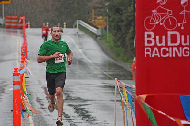 Auburn's James Roach reaches the finish line to take the 10-kilometer overall win at the 33rd Christmas Rush Fun Run/Walk in Kent on Saturday morning.