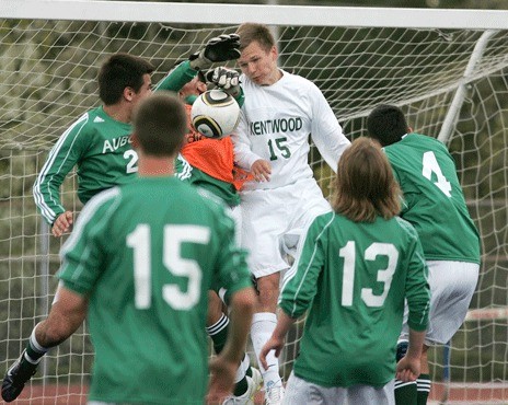 Kentwood's Cody Crook fights to head in a goal against Auburn's Ramone Lopez