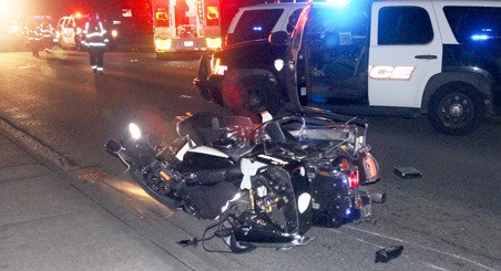 Police and paramedics respond after a Kent Police motorcycle officer crashed his bike Tuesday night along Central Avenue North after hitting a median. Paramedics took the officer to a hospital for precautionary treatment of undisclosed injuries.