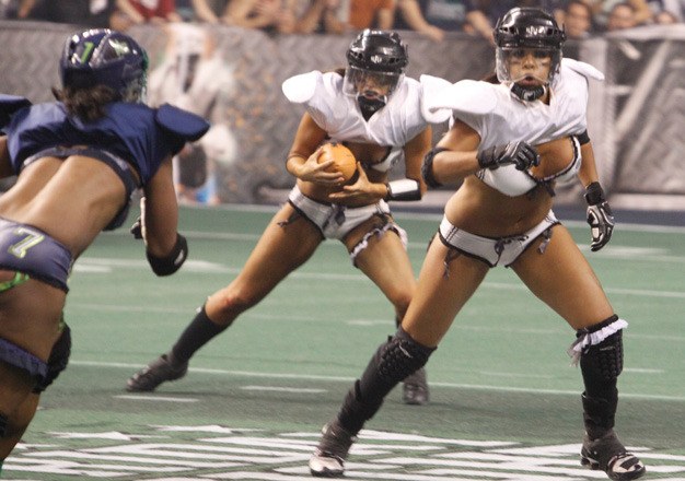 A Seattle Mist defender pursues a Los Angeles Temptation running back during a Lingerie Football League game last season in Kent.