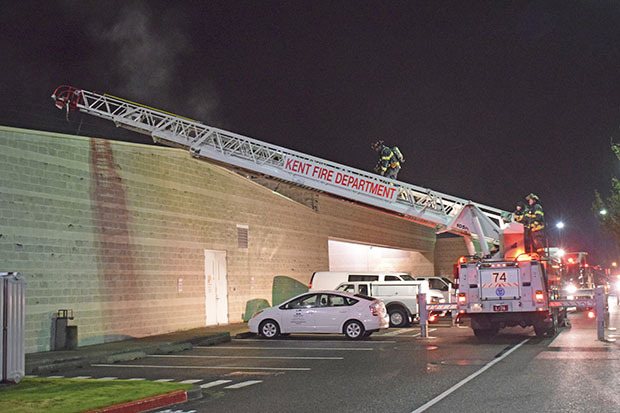 Kent firefighter approach the roof of the Regional Justice Center to see if the fire had spread. Firefighters quickly contained and doused the early Friday morning fire.