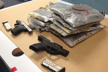 Kent Police display heroin and pistols seized during and after a May 22 arrest in Kent.