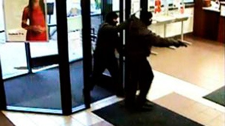 Two men enter a Key Bank in Bellevue during a Nov. 19 robbery. Police later identified one of the men as Jason T. Achurra