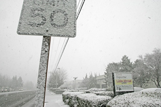 02/23/11 Snow is building up  fast on West Valley Highway and the signs in front of the Kent Reporter offices Feb. 23.