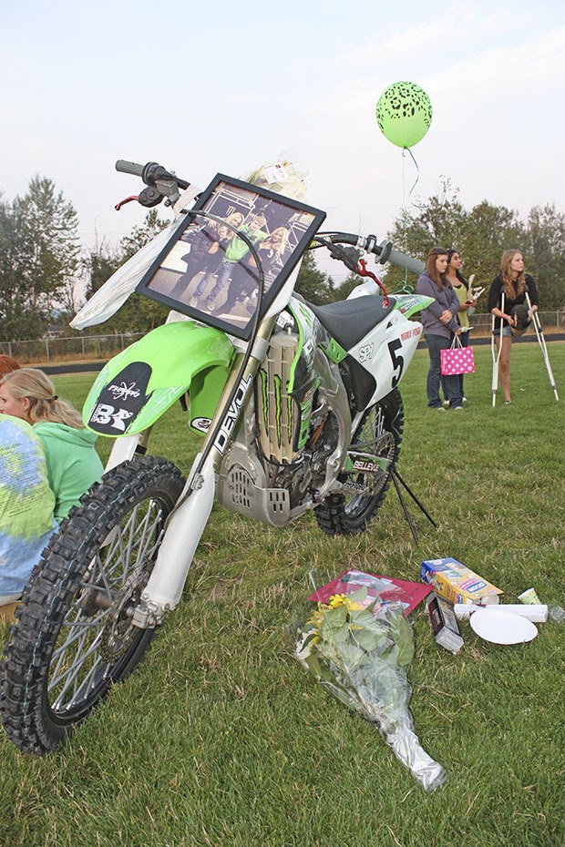 Family and friends paid tribute to the late Chase Stancil with a vigil last Friday night. Flowers and  momentos are placed by one of Stancil's motorcycles.