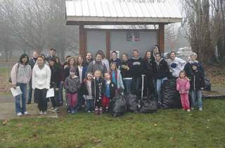 Community volunteers pose for a photo after the city clean-up event Jan. 19 on the Interurban Trail in Kent.