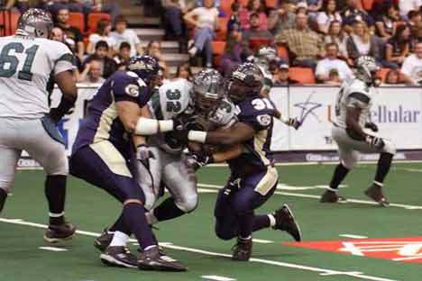 Tri-Cities players make a gang tackle during a recent Arena Football League 2 game at the Tri-Cities.