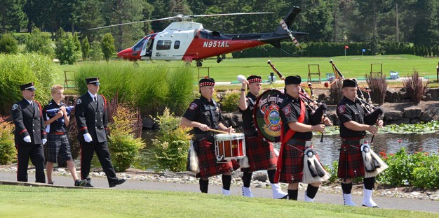 Members of the Pierce County Drum and Pipe Corp escort a Kent Fire Department honor guard contingent and Colton Hauer Thursday