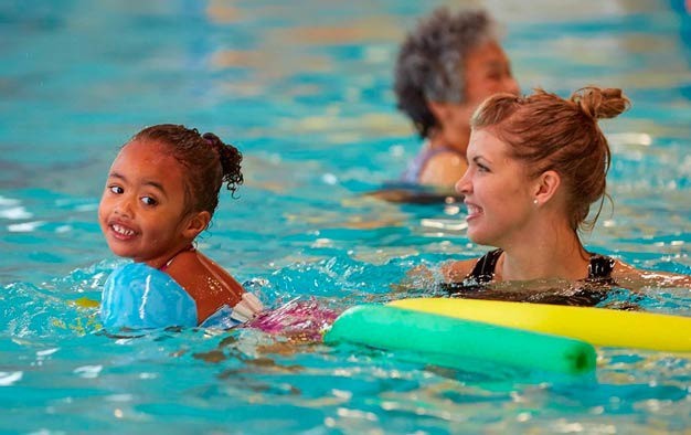 Adults and children enjoy the pool at the Matt Griffin YMCA in SeaTac. The YMCA of Greater Seattle plans to open a facility with a gym and pool on Kent's East Hill in the next three to five years.