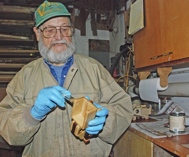 Vern Heinle works on a toy inside of his workshop. This Christmas season