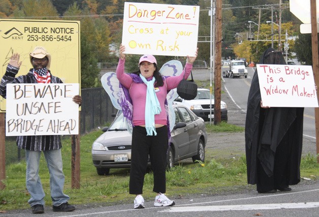 Several Working Washington members dressed up in costumes and held protest signs against the state of the Alvord T. Bridge on Halloween Day.