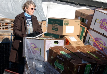 Kent resident Sharon Carter prepares to unload produce for a food bank she runs out of her East Hill home. City officials say the food bank violates city code.