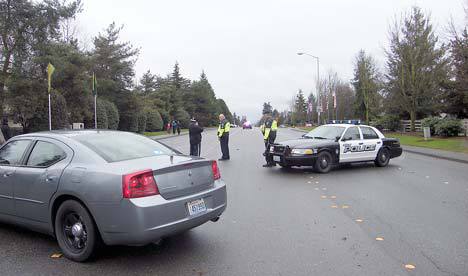 Kent Police park their cars in a closure of the Kent-Kangley Road in Kent Friday afternoon