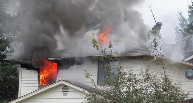 Firefighters battle a blaze Thursday morning at a two-story Kent duplex in the 10900 block of Southeast 250th Court.