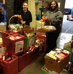Kent Food Bank's executive director Jeniece Choate and supervisor Camico Rivon receive the Kent Turkey Challenge donations on Nov. 16.