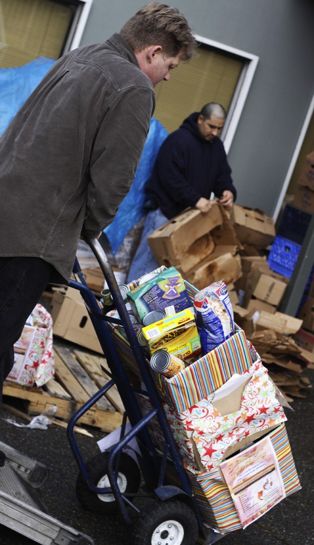 Torklift Central employees unload boxes of food as a part of the company's Turkey Challenge. The event raised  $10