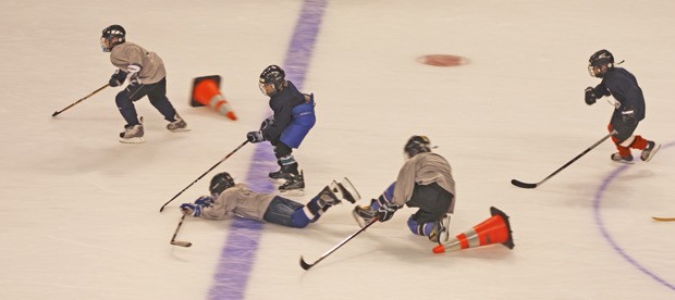 Players in the 11-12-year-old age group break away while trying to avoid sliding cones that test their agility during the Seattle Thunderbirds’ fourth annual Hockey School at the ShoWare Center. T-Bird coaches and players led on- and off-ice training and instruction throughout the week.