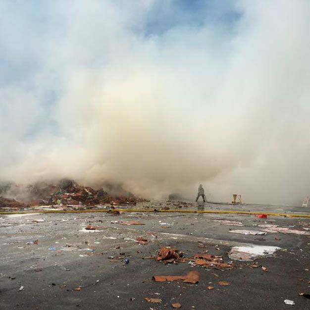 Firefighters battle a blaze Wednesday afternoon at a recycling plant in the 1400 block of Sixth Avenue North.